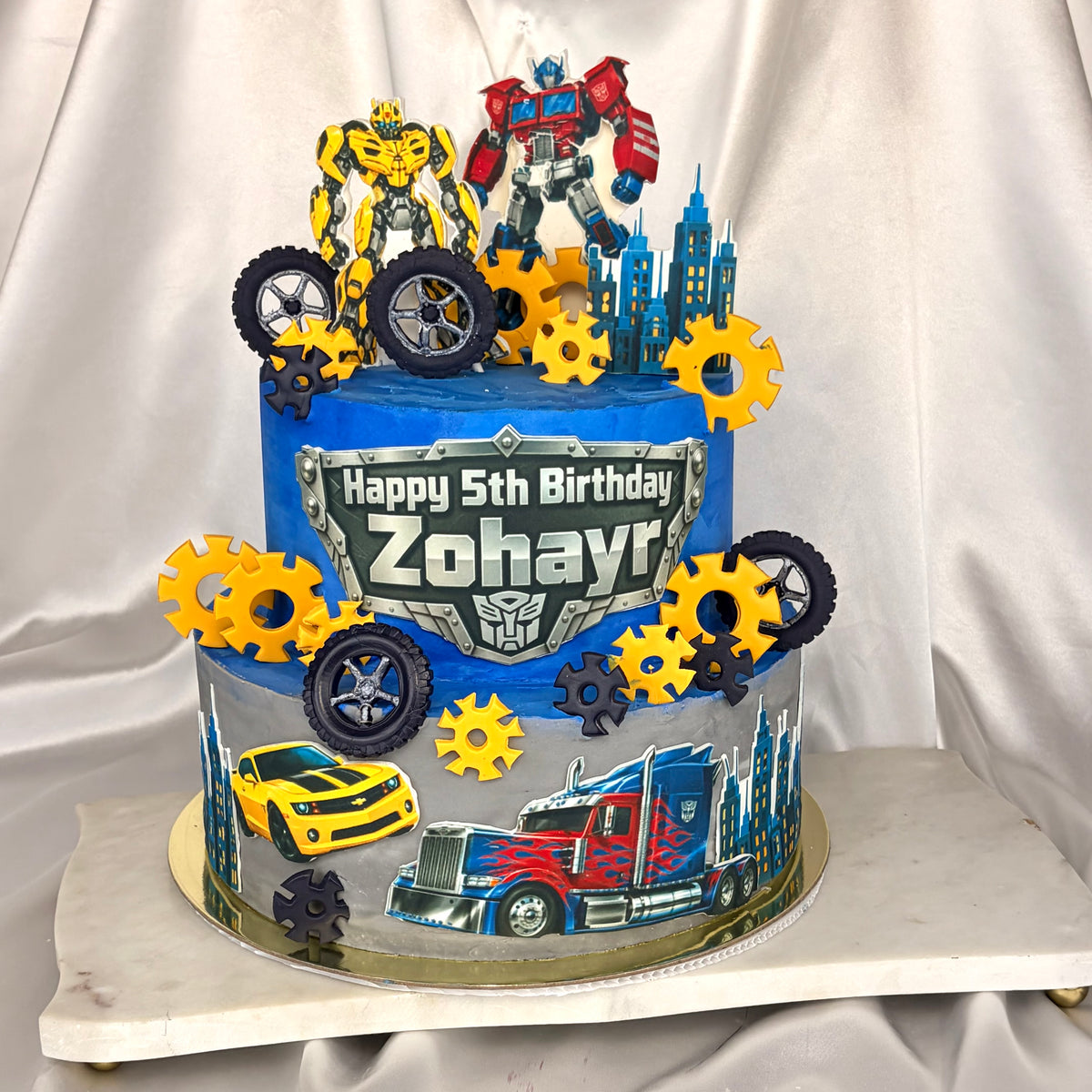 Transformers-Themed Two-Tier Birthday Cake with Custom Name Plaque