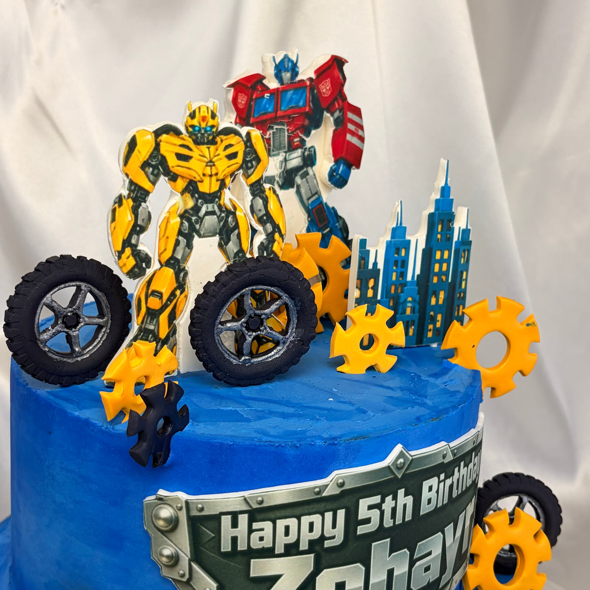 Transformers-Themed Two-Tier Birthday Cake with Custom Name Plaque