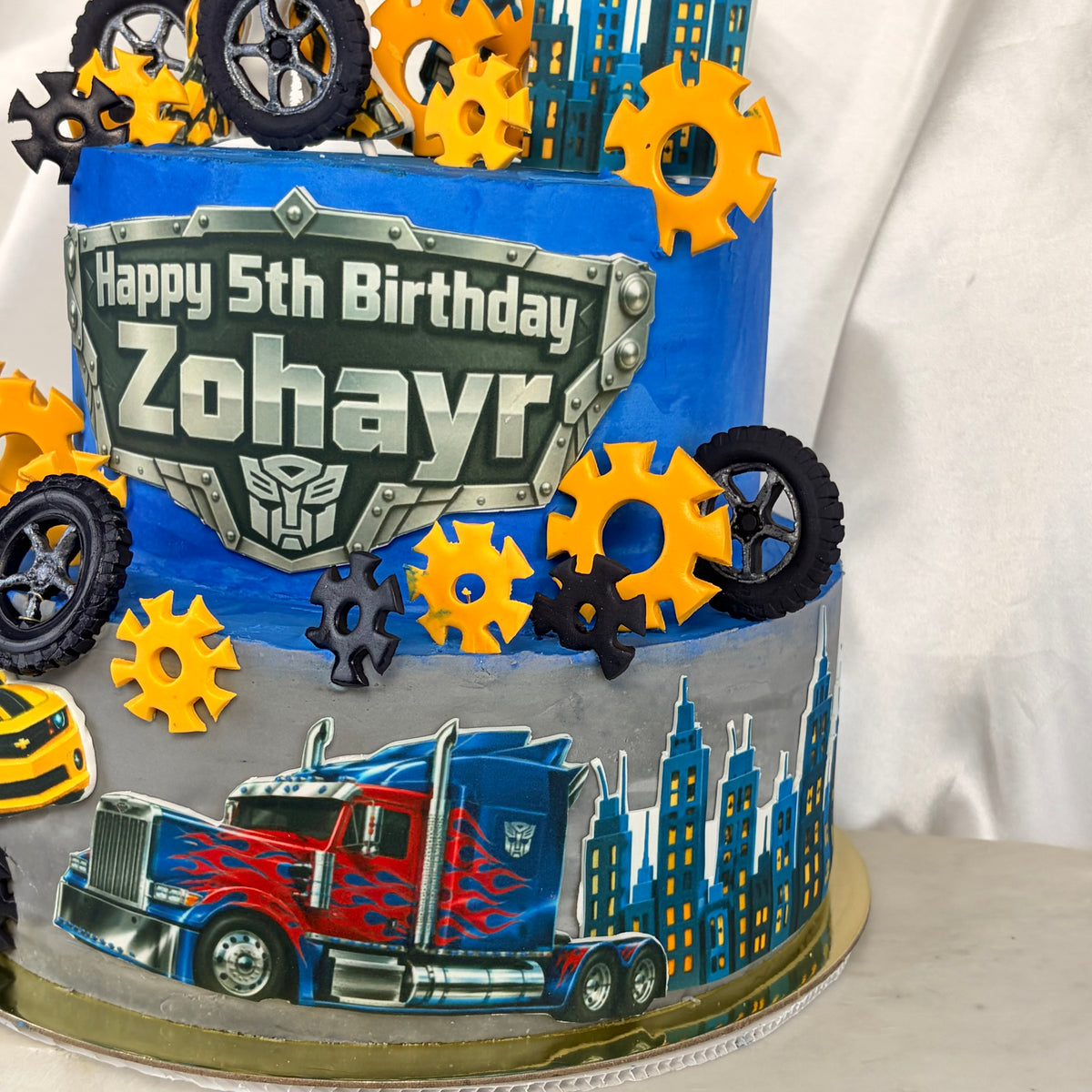 Transformers-Themed Two-Tier Birthday Cake with Custom Name Plaque
