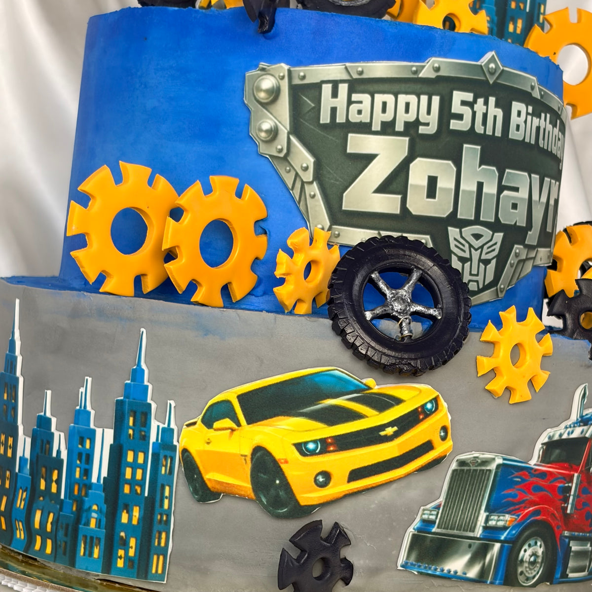 Transformers-Themed Two-Tier Birthday Cake with Custom Name Plaque