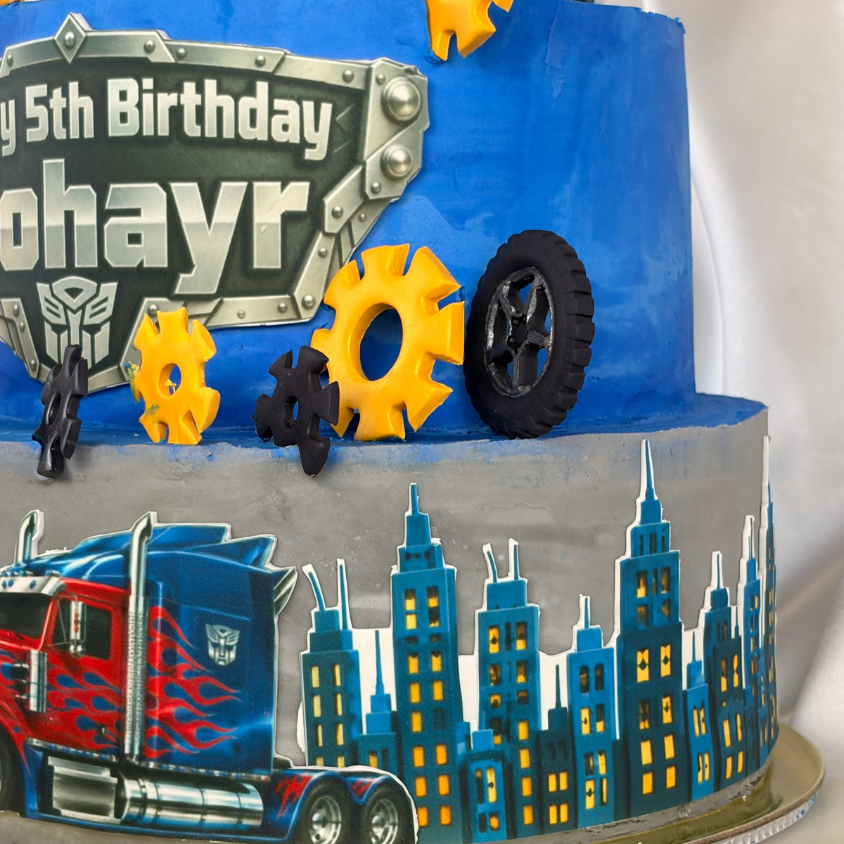 Transformers-Themed Two-Tier Birthday Cake with Custom Name Plaque