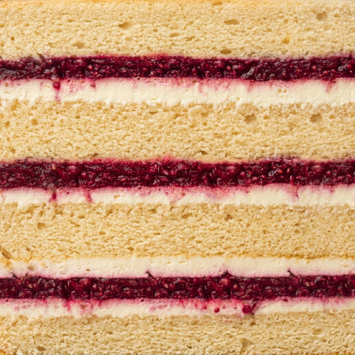 Slice of cream cheese and raspberry confit cake
